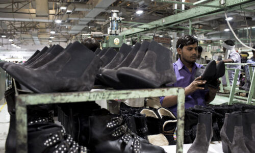 Footwear Manufacturing At A Virola Shoes Factory A worker performs quality-control inspections on shoes on the assembly line